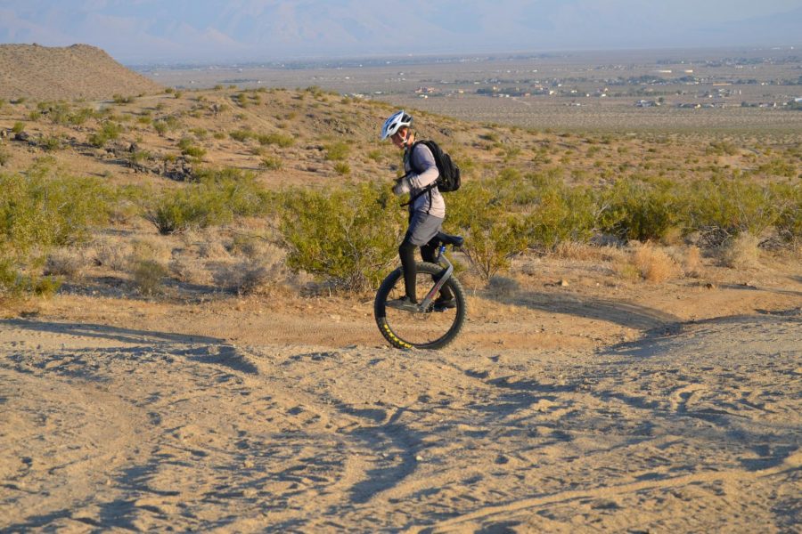 Cayden Houck rides on the trails with his special Hatchet mountain unicycle. 