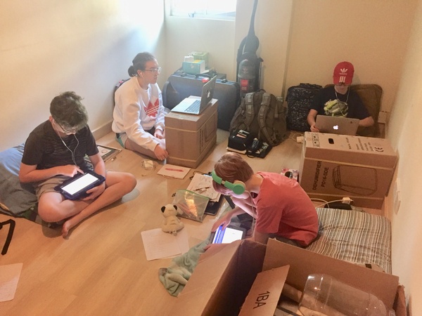 Burroughs freshman Sophia Pendergast (second from left) and her brothers finished out their Singapore school year in their makeshift virtual learning headquarters as their house was packed up for the big move. 
