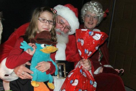 A throwback picture of sophomore Addie Gerber showcases her familys traditional visit with Santa Claus. 