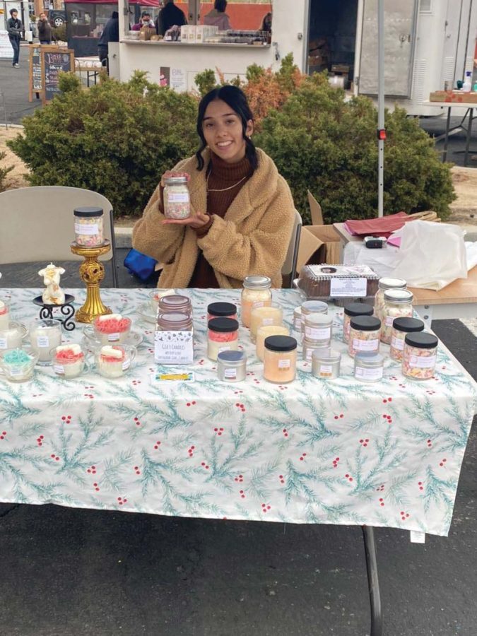 Senior Gia Croos-Peterson selling a variety of candles at the local Farmers Market. 