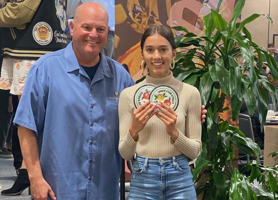 CIF+Southern+Section+Commissioner+Rob+Wigod+%28above%29+honors+senior+track+athlete+Gia+Croos-Peterson+at+the+Citrus+Belt+Area+Outstanding+Athlete+Breakfast+held+at+the+University+of+Redlands.+Andrew+Mower+%28XC%2FTrack%29+could+not+attend+due+to+AP+testing%2C+but+his+picture++made+the+front+cover+of+the+program+for+the+event.