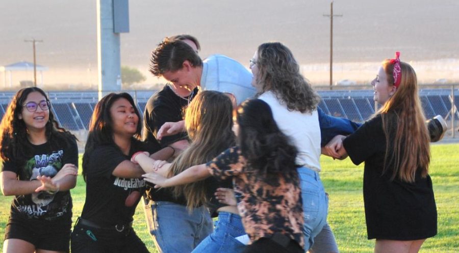 An Uplifting Experience: Junior Cayden Houck gets some support from his fellow ASB crew as they practice for the schools Friday morning rally.  