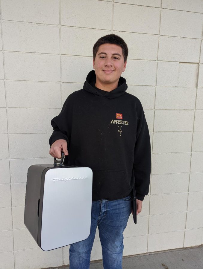 Junior Jayden Park uses a mini refrigerator to carry his schoolwork for Anything But a Backpack Day. 
