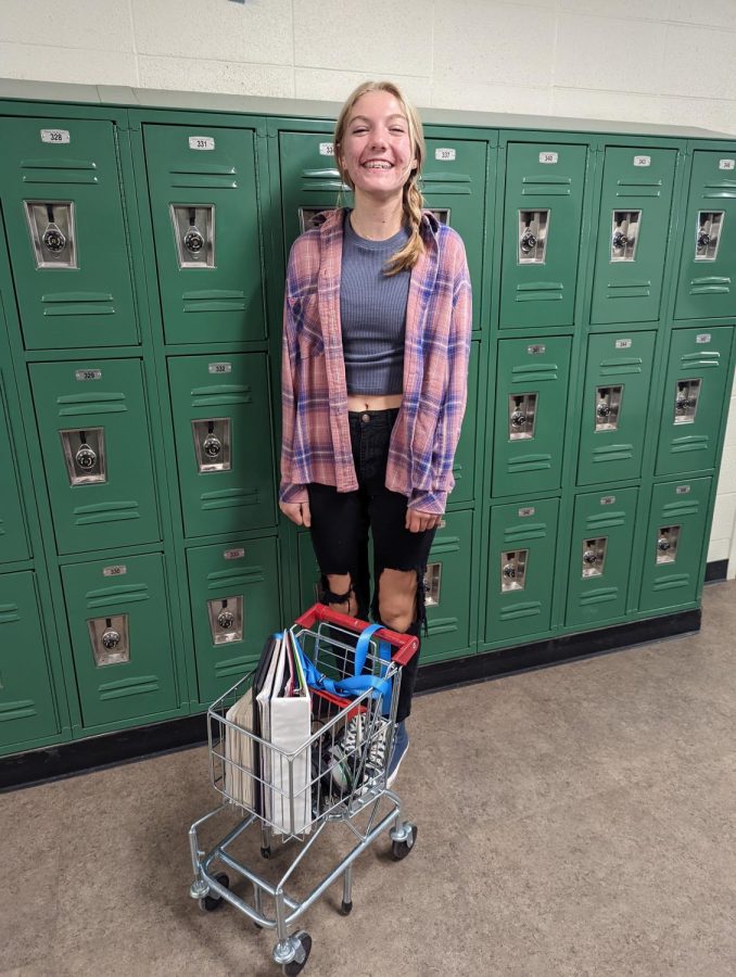 Freshman Paige Dunn carries her schoolwork in a mini shopping cart for Anything But a Backpack Day.