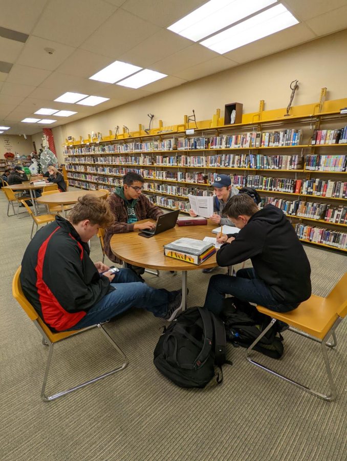 Sophomore Parker Anderson and juniors Isaac Eggleston, David Miranda, and Eldon Mason study for their finals in the library.