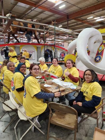 Interact Club students cut flower pedals to apply to the Rotary Rose Parade float.