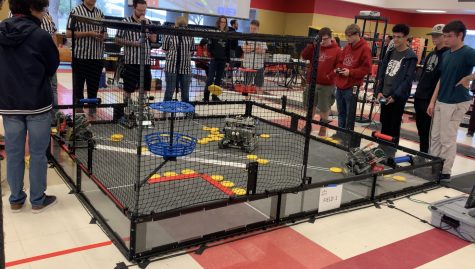 (Far right) Burroughs Robotics members Kevin Jones, Ian Patin, and Rowan Nelson compete to secure a spot at the state championships. 