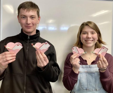 Archery Club members Ethan Nutter and Addie Gerber display the new Cupid Gram design!