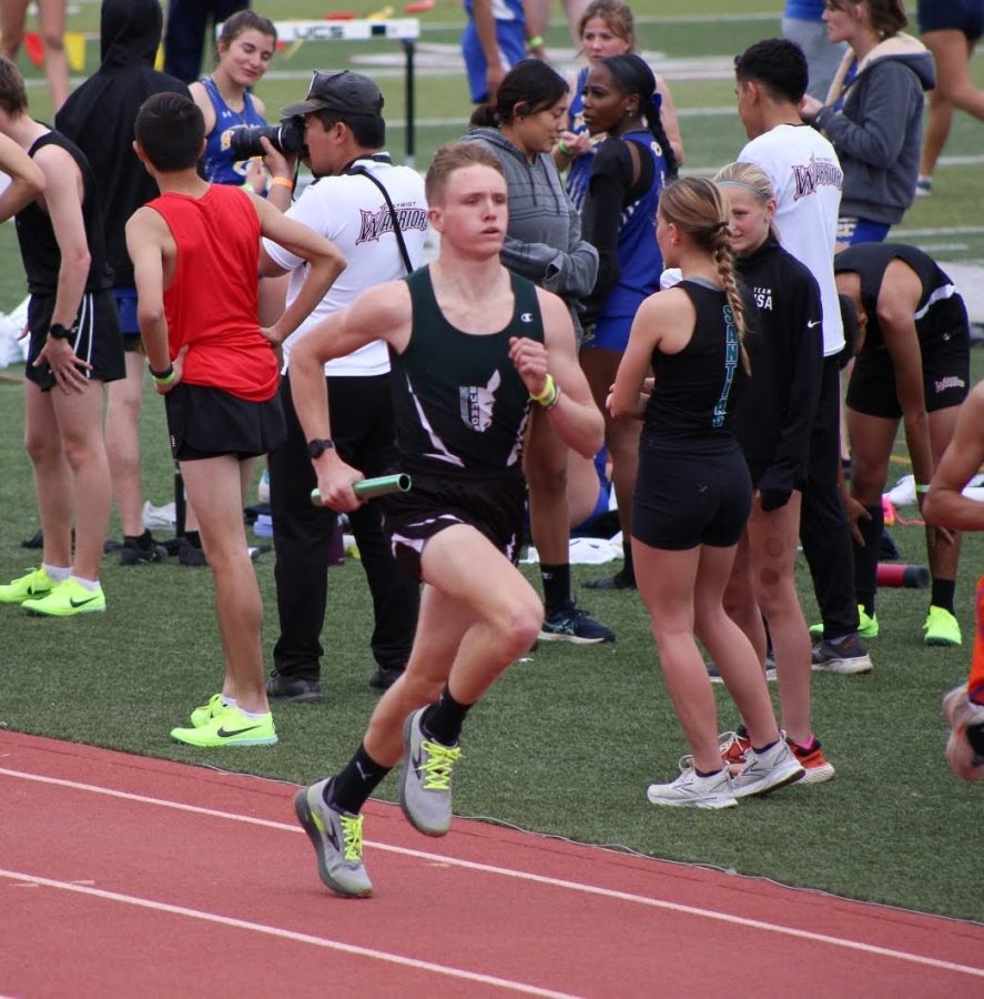 Junior Sam Andrus making a strong stride towards the finish at his track meet.