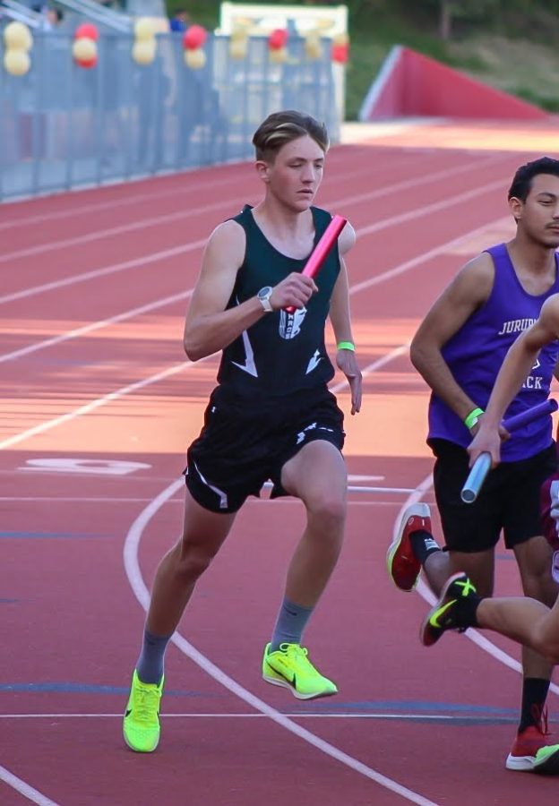 Freshman Matthew Kimbler strides towards the finish in his Distance Medley Relay.