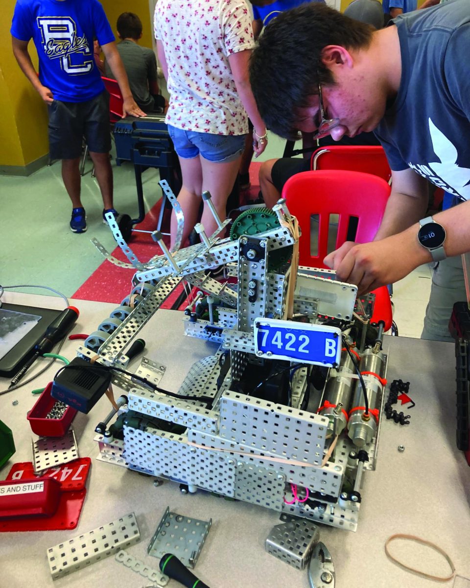 Sophomore Kevin Jones  works on his team’s robot before the competition.                                                                                                             
