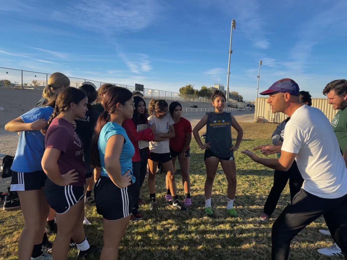 Coach Marvin directing the Lady Burros soccer team.