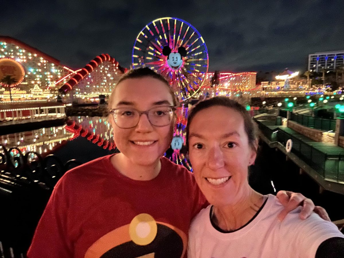 Senior Sophia Pendergast and her mom, Angela Pendergast, pose in front of Pixar Pier during the Disneyland Half Marathon. 