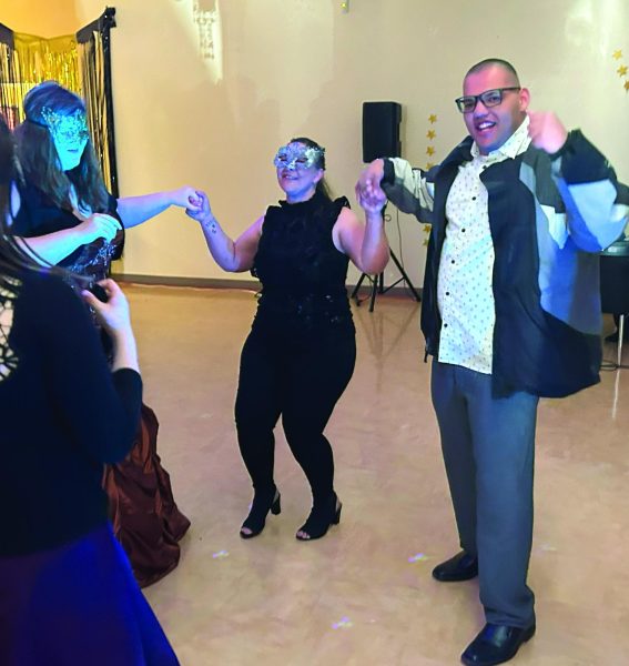 Mikaylah Flores, Special Education Teacher Melissa Moroz, and Isiah Robinson enjoy dancing together at Prom.