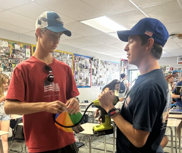 Senior Class Vice President Jimmie Winder and ASB President Ryan Morrison prepare the items needed for the rally games.  
