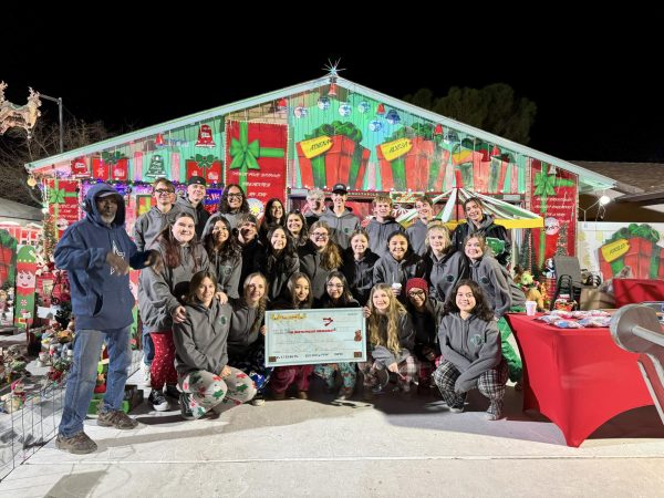 The Burroughs ASB class presents the school's $821 donation to Tony Malone, the chief elf at the North Pole at Ridgecrest. 