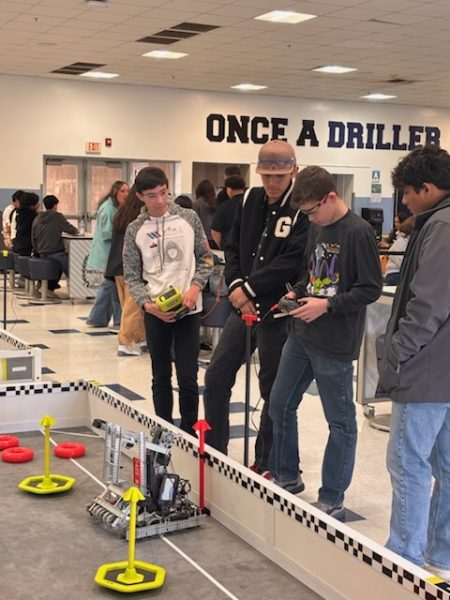 Tyler Bietnes, Talen Houck, and Angel Valiente of team 7422B set up for their last driver skills run during the "Last Chance" event on Feb. 8 at Bakersfield High School. 