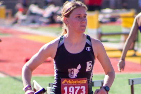Eve Washburn takes off the start line, baton in hand, ready to dominate the track.