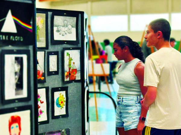 Sophomores Dannika Nelson and Quan Laskey check out the artwork on display.