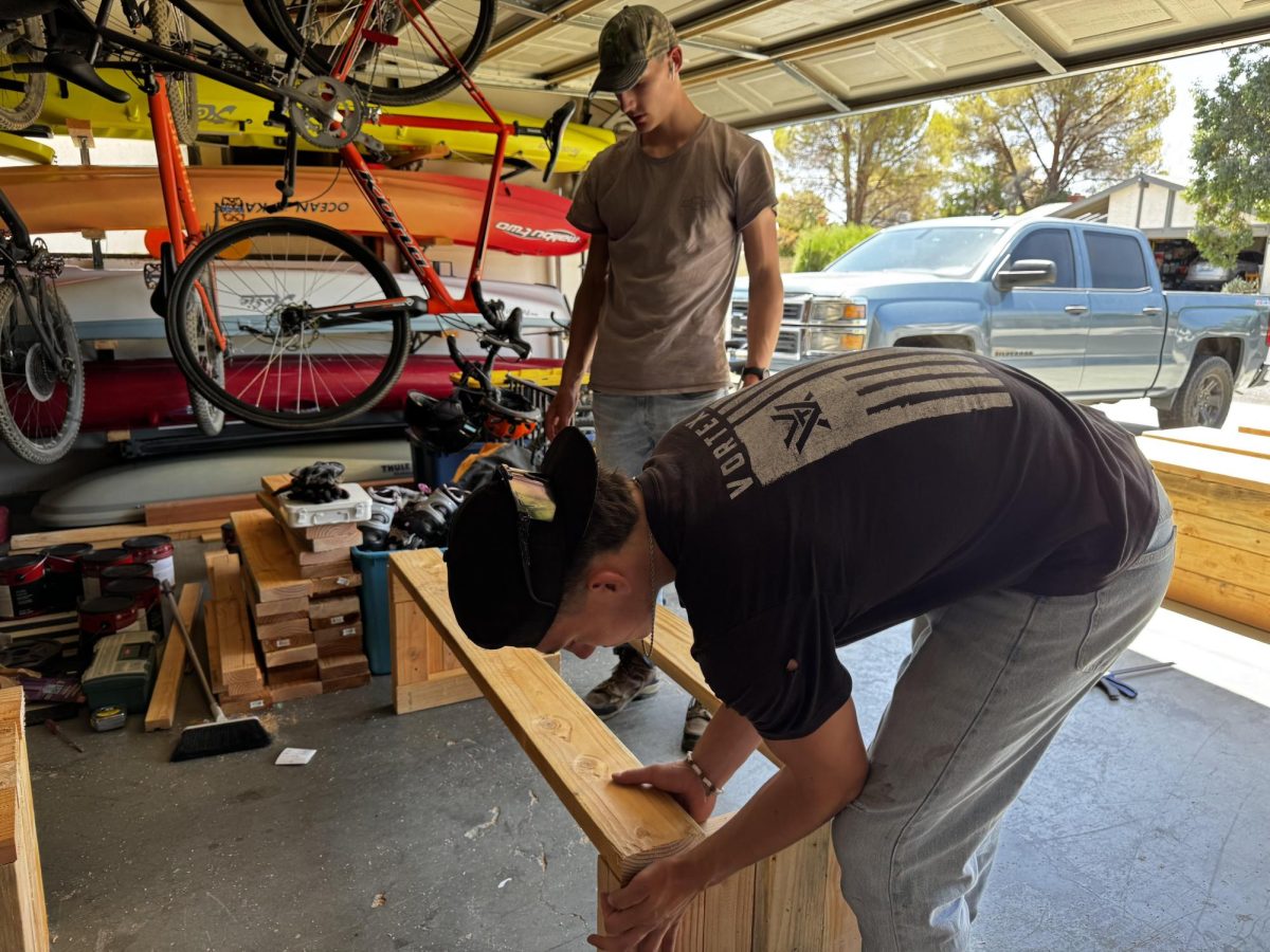 Junior Eli Eggleston and his brother, BHS graduate Kjeaton Eggleston,  work on benches for China Lake Junior High.