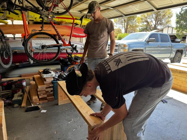 Junior Eli Eggleston and his brother, BHS graduate Kjeaton Eggleston,  work on benches for China Lake Junior High.