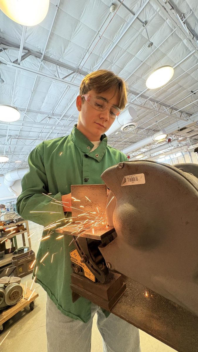 Senior Patrick Boggs grinds down his first welding project