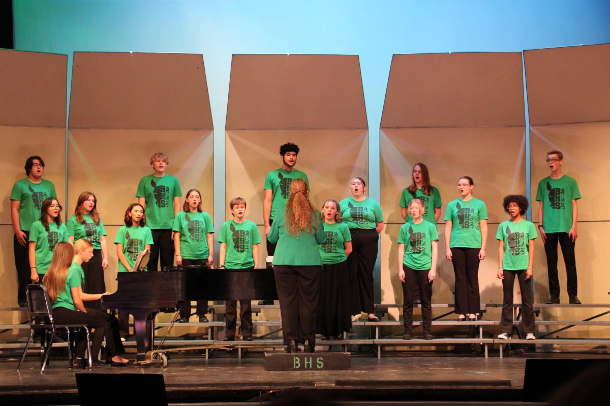 The Burroughs Madrigal Singers, under the direction of Amber Petersen and accompanied by junior Annabelle Winder, take the stage during the fourth annual Culture-Fest.