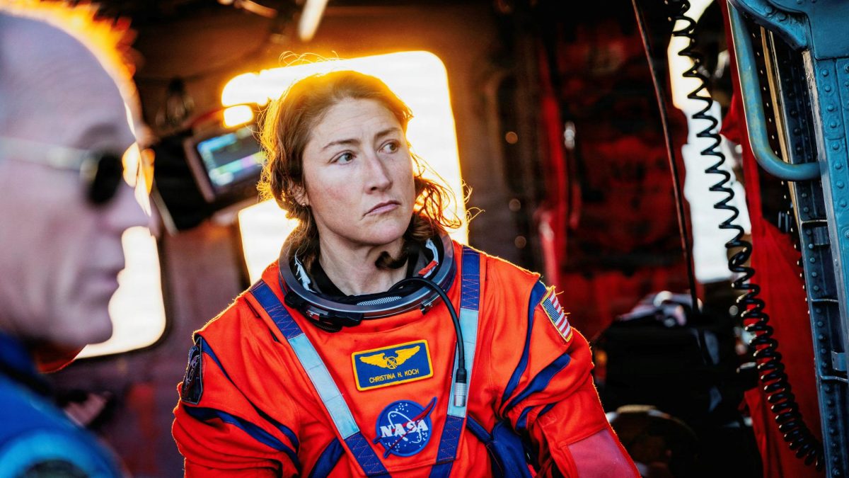 NASA astronaut Christina Koch sits in a U.S. Navy MH-60S Seahawk on the flight deck of the U.S. Navy's USS John P. Murtha after returning from their Artemis II Moon flyby.   