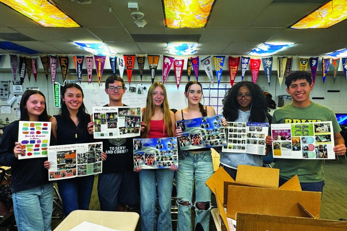 Yearbook staff Siona Otillio, Jasmine Casas Flores, Aiden Thibado, Kristen Stacy, Lexie Gross, Jayla Cobbs-Fuller, and Daniel Gamboa unbox their printed pages from the spring insert. 